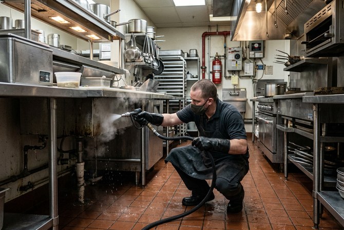 Steam wand cleaning beneath a stainless steel counter line